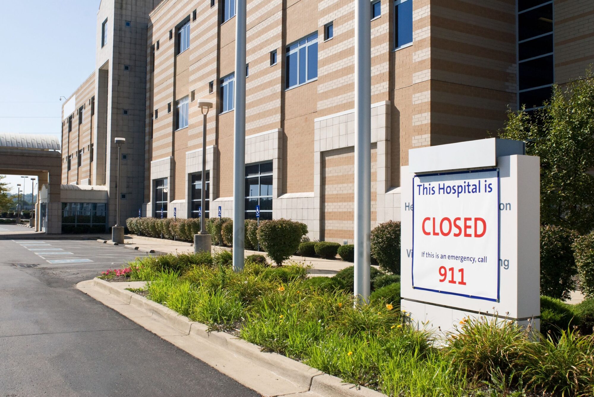 Closed sign in front of hospital building